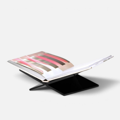 Shop Rescue Spa black Assouline bookstand displaying an open coffee table book on a white background