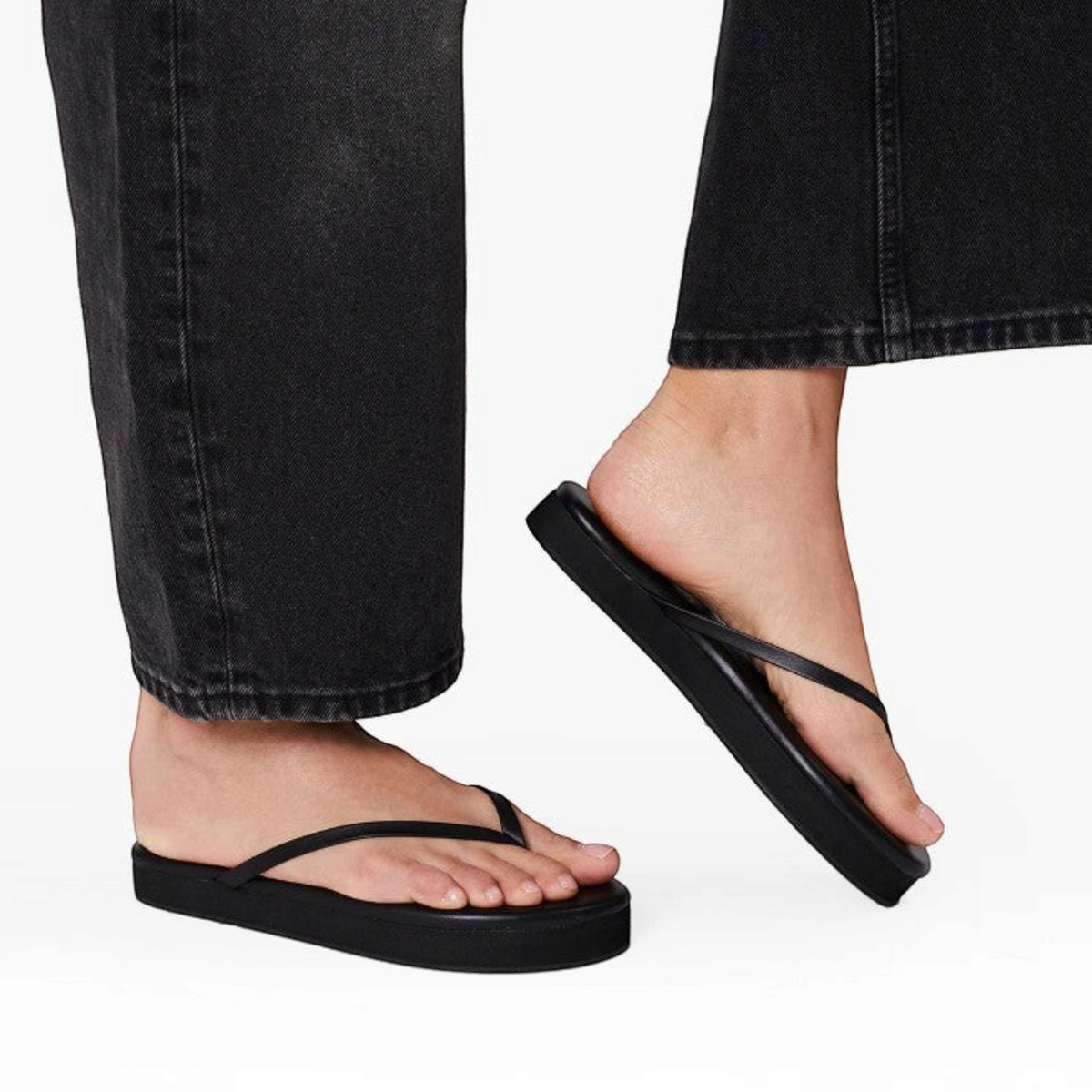 Shop Rescue Spa Lily Platforms in black leather with a 2.5 cm cushioned sole worn on feet with black jeans