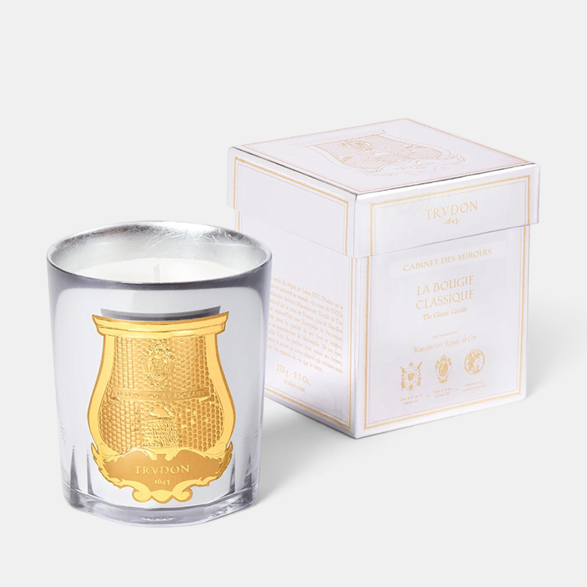 Shop Rescue Spa Trudon Cabinet des Miroirs candle with silver mirror finish glass and gold emblem next to gift box