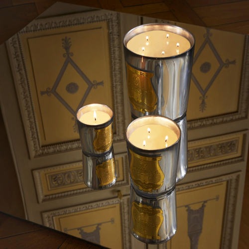 Shop Rescue Spa Cabinet des Miroirs candles in celadon glass with silver leaf mirror finish on a reflective surface.