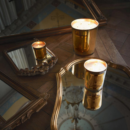 Shop Rescue Spa Galerie des flammes candles in gold mirror-finish glass on a wooden table with ornate mirrors