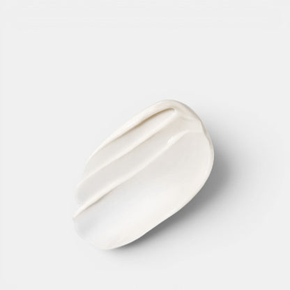 Cream swatch showing the rich, smooth texture of The Overnight Restorative Cream with a soft shadow on a grey background.