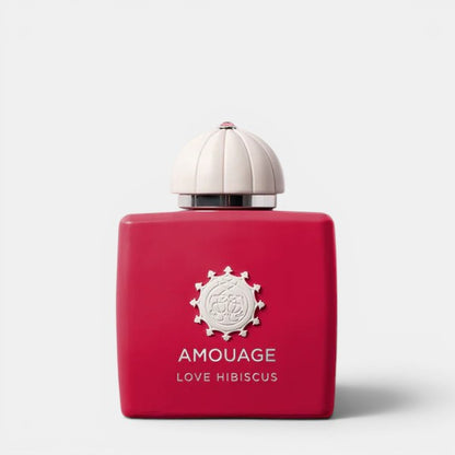 Red Amouage perfume bottle with white cap on a light gray background