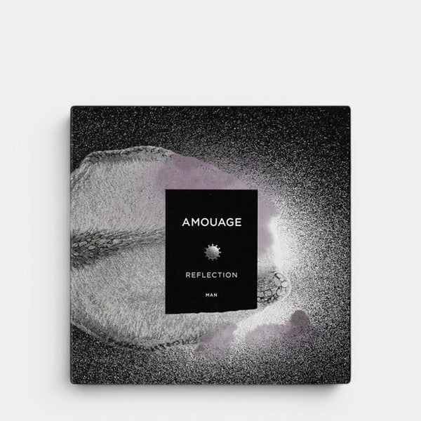 Amouage Reflection Man perfume packaging on a grey background