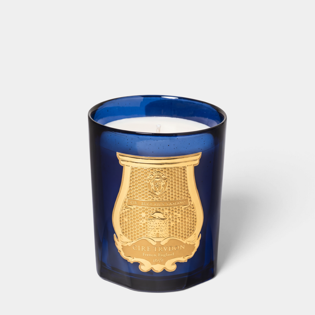 Shop Rescue Spa Salta Classic Candle in a deep blue glass vessel with a gold embossed crest label