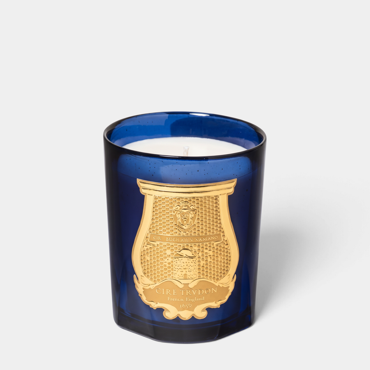 Shop Rescue Spa Salta Classic Candle in a deep blue glass vessel with a gold embossed crest label