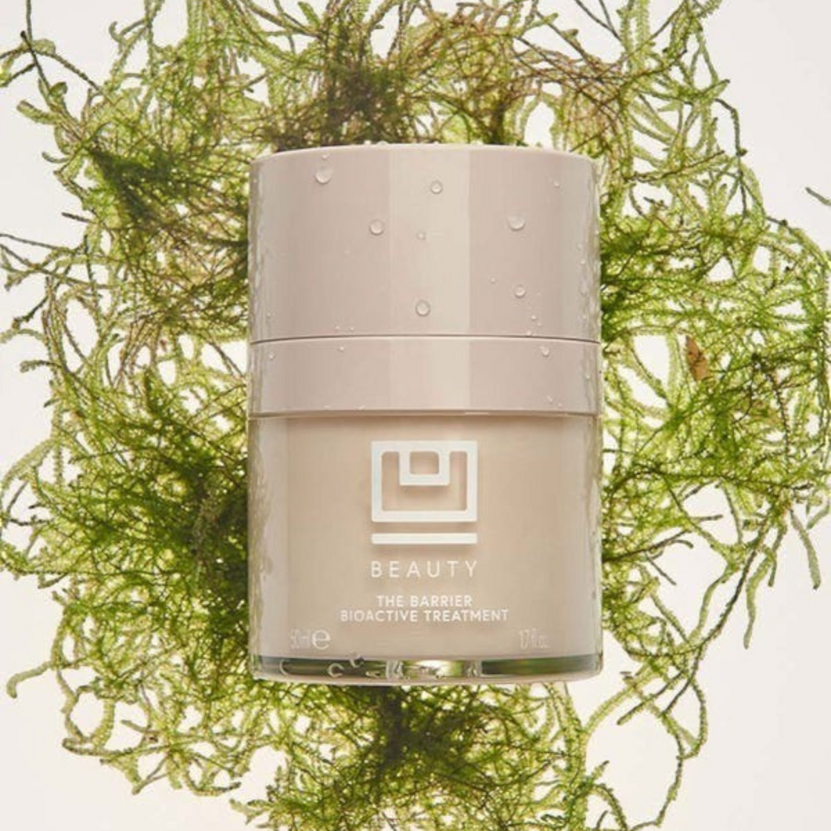 Shop Rescue Spa The Barrier Bioactive Treatment in a beige jar surrounded by green sea moss on a white background.