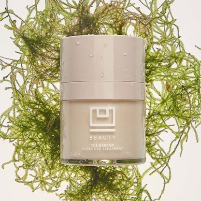 Shop Rescue Spa The Barrier Bioactive Treatment in a beige jar surrounded by green sea moss on a white background.