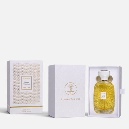 Shop Rescue Spa Nuda Veritas perfume bottle with gold flakes inside, presented in an elegant white and gold gift box.