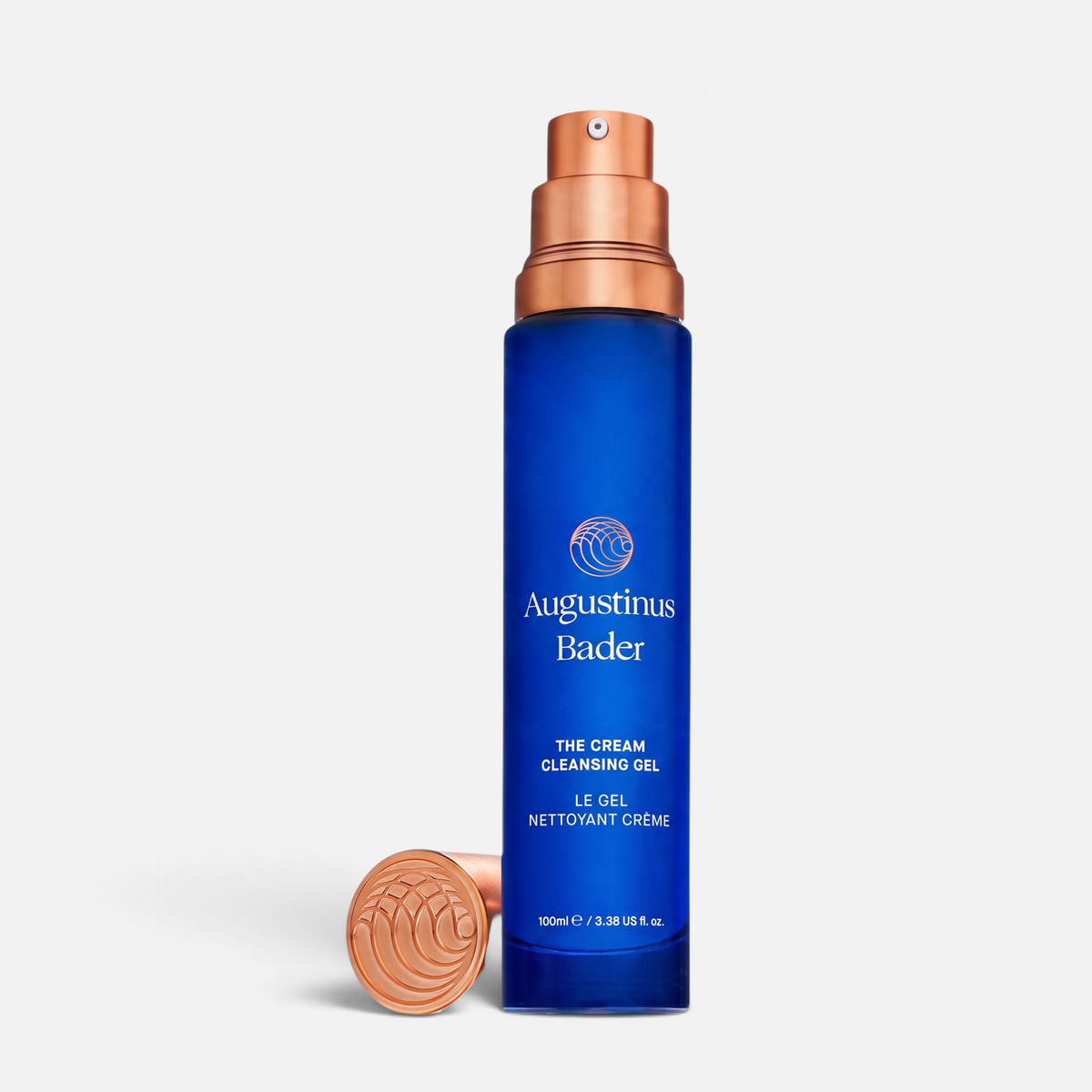 Shop Rescue Spa Augustinus Bader The Cream Cleansing Gel in a blue glass bottle with a metallic copper pump