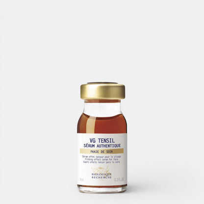 VG Tensil Sérum Authentique 0.3 fl. oz – A clear glass bottle filled with brown liquid, topped with a gold cap. The product features a branded white label with blue lettering, photographed against a clean white background. This smaller size of the firming botanical serum by Biologique Recherche is ideal for travel or targeted skincare routines.