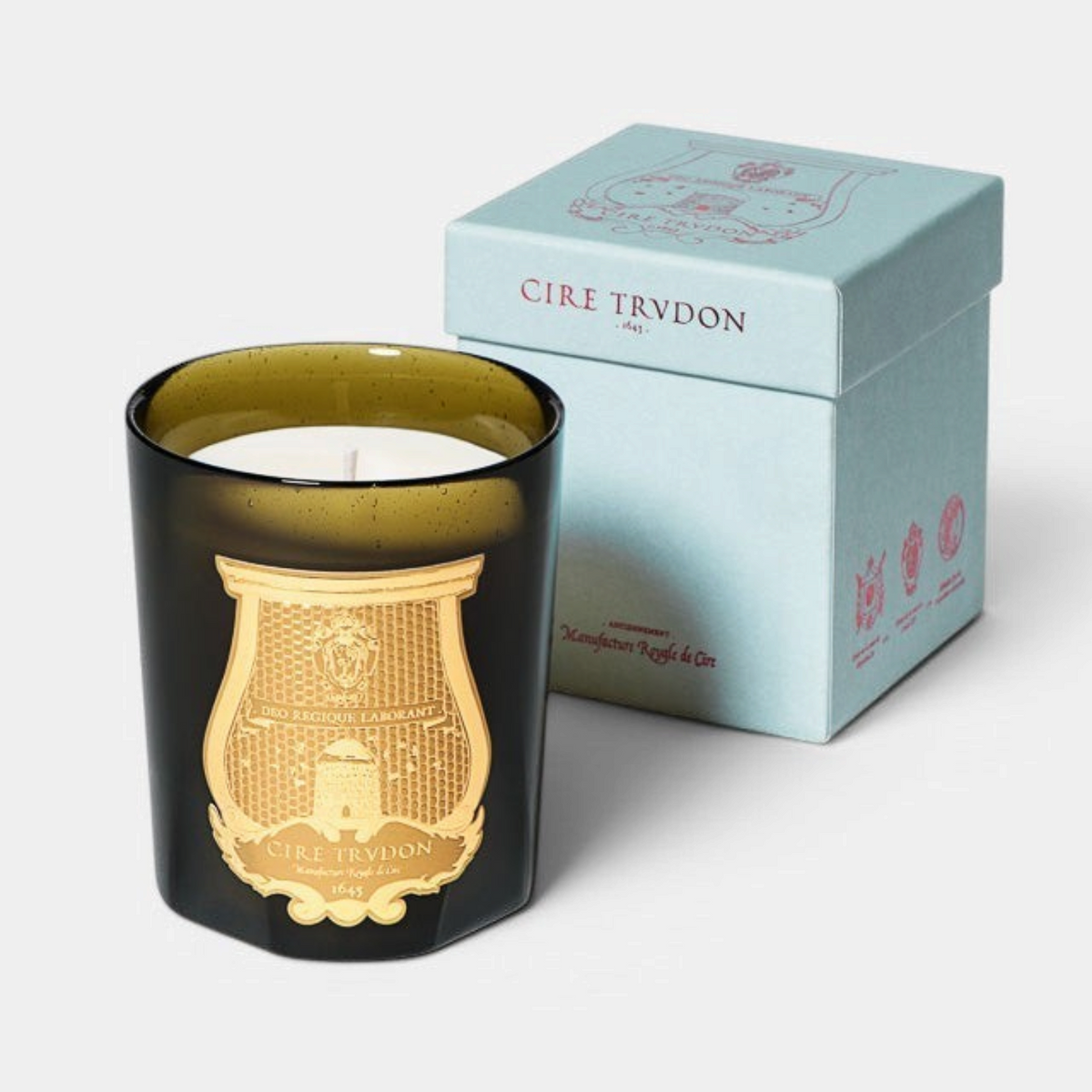 Shop Rescue Spa Solis Rex Classic Candle in a dark green glass vessel with a gold emblem and light blue gift box.