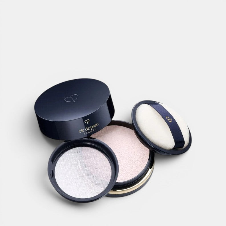 Cle De Peau Beaute Translucent Loose Powder, position centered and open with a white background. Sets and perfects skin for a flawless, luminous finish.