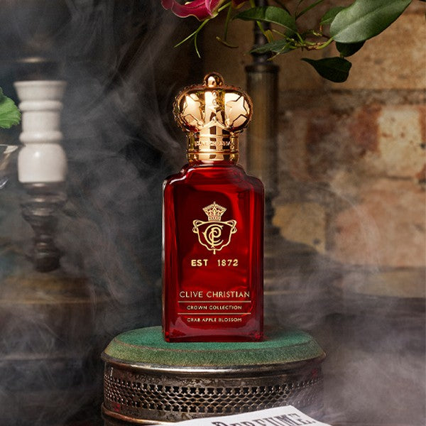Lifestyle image of Clive Christian Crab Apple Blossom Parfum with perfume bottle set against a smoky, atmospheric background, highlighting the fragrance bottle silhouette and presentation.