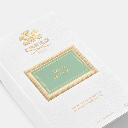 Angled view of Creed Wild Vetiver perfume box on a clean background, highlighting side and front panels of the packaging.