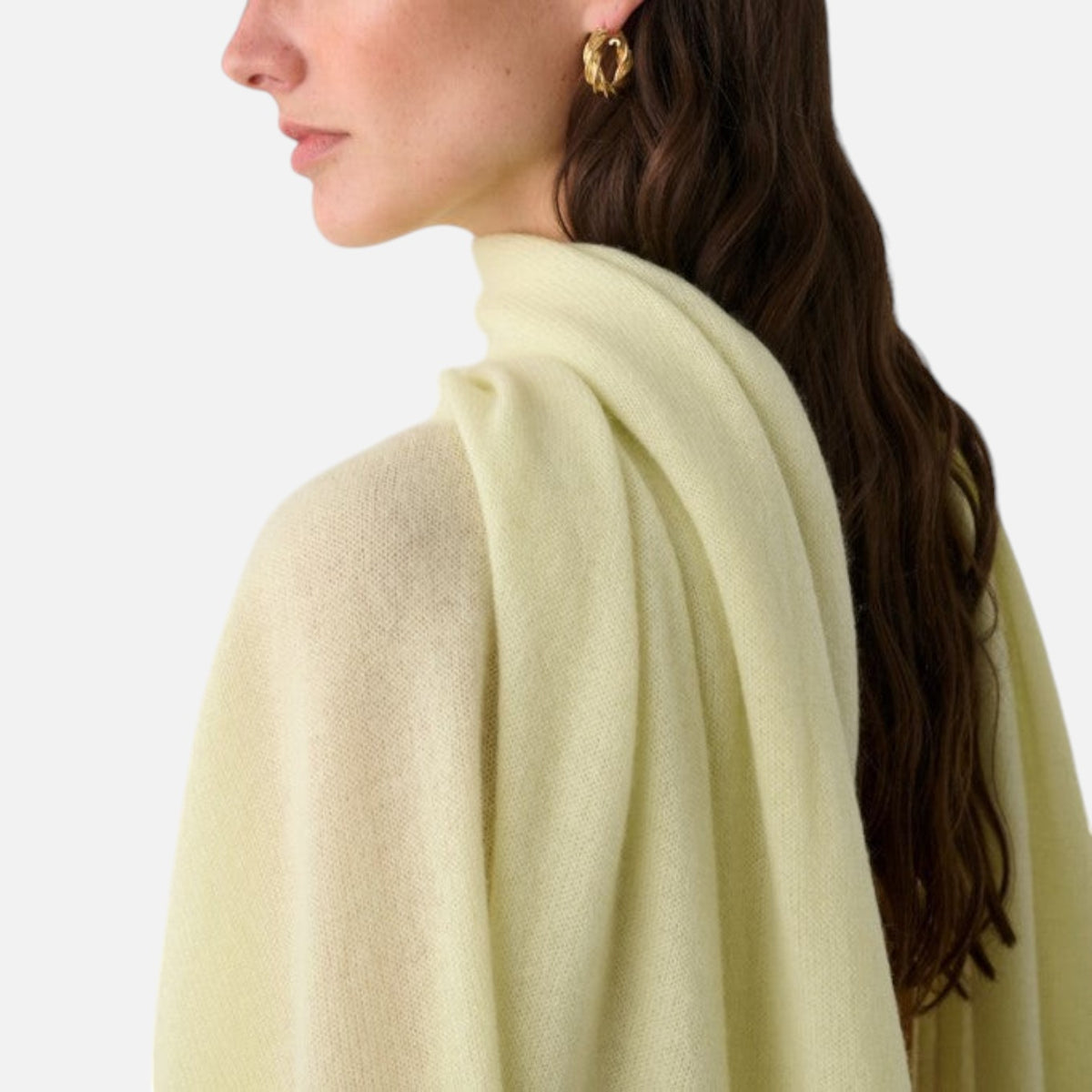 Shop Rescue Spa pale yellow cashmere travel wrap draped over a woman&
