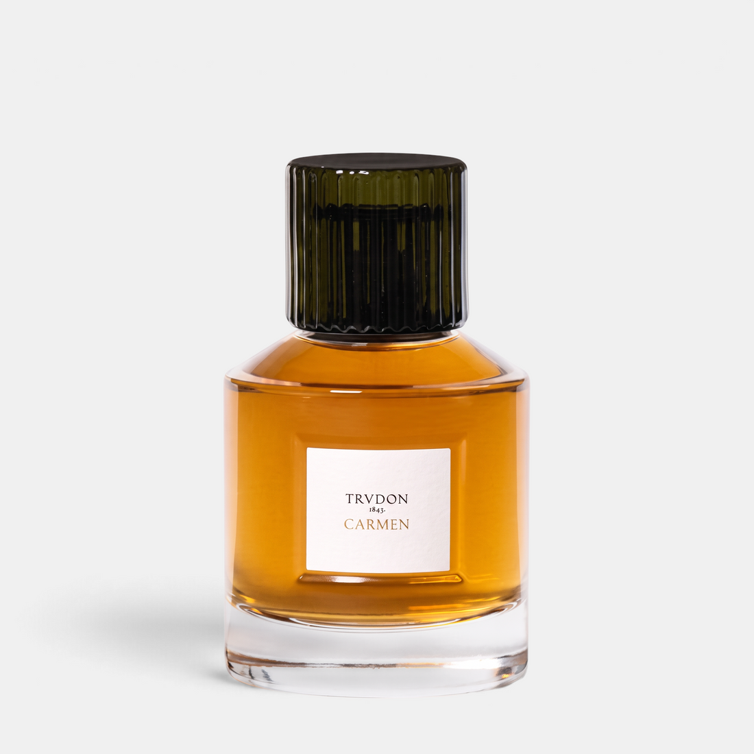 Shop Rescue Spa Trudon Carmen Eau de Parfum in a clear glass bottle with a dark ribbed cap and amber fragrance liquid.