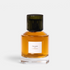 Shop Rescue Spa Trudon Carmen Eau de Parfum in a clear glass bottle with a dark ribbed cap and amber fragrance liquid.