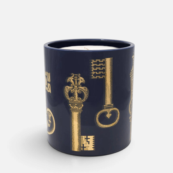 Shop Rescue Spa Fornasetti Chiavi scented candle in a dark blue ceramic vessel with gold key illustrations.