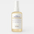 A clear glass bottle of Biologique Recherche Huile Fondamentale with a golden botanical oil inside, featuring a white label and gold cap, photographed on a clean white background.