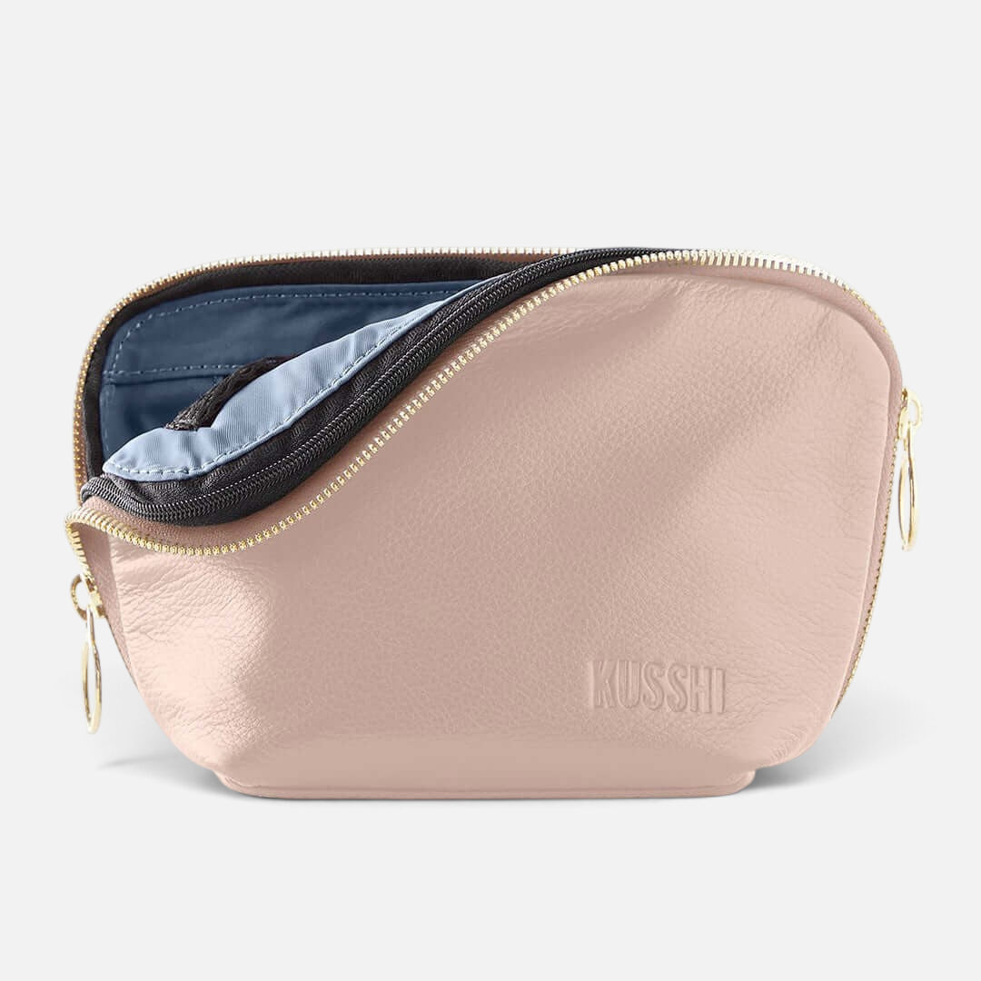 Shop Rescue Spa Everyday leather makeup bag in soft pink with a zip-out interior liner and gold-tone zipper.