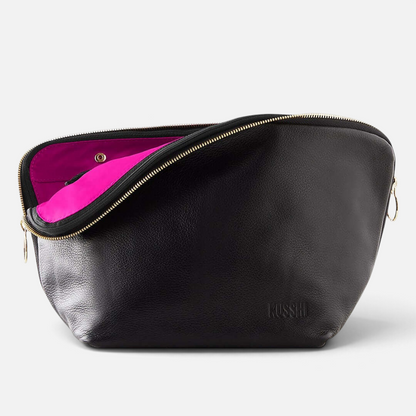 Shop Rescue Spa Vacationer makeup bag in black leather with a vibrant pink interior and gold zipper detail.