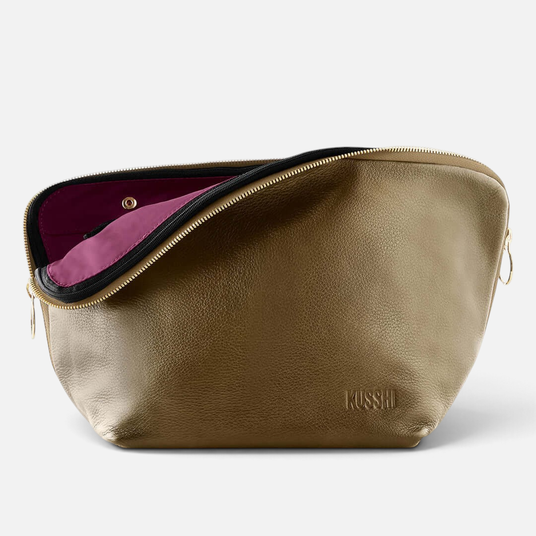 Shop Rescue Spa Vacationer makeup bag in metallic olive leather with a vibrant purple interior and gold zipper