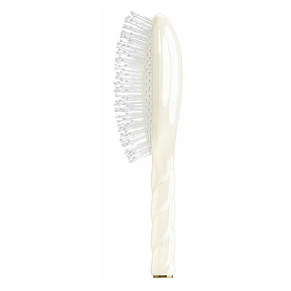 Hairbrush with white bristles on a white background