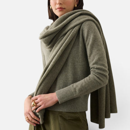 Shop Rescue Spa olive green cashmere travel wrap draped over a model wearing a matching knit sweater