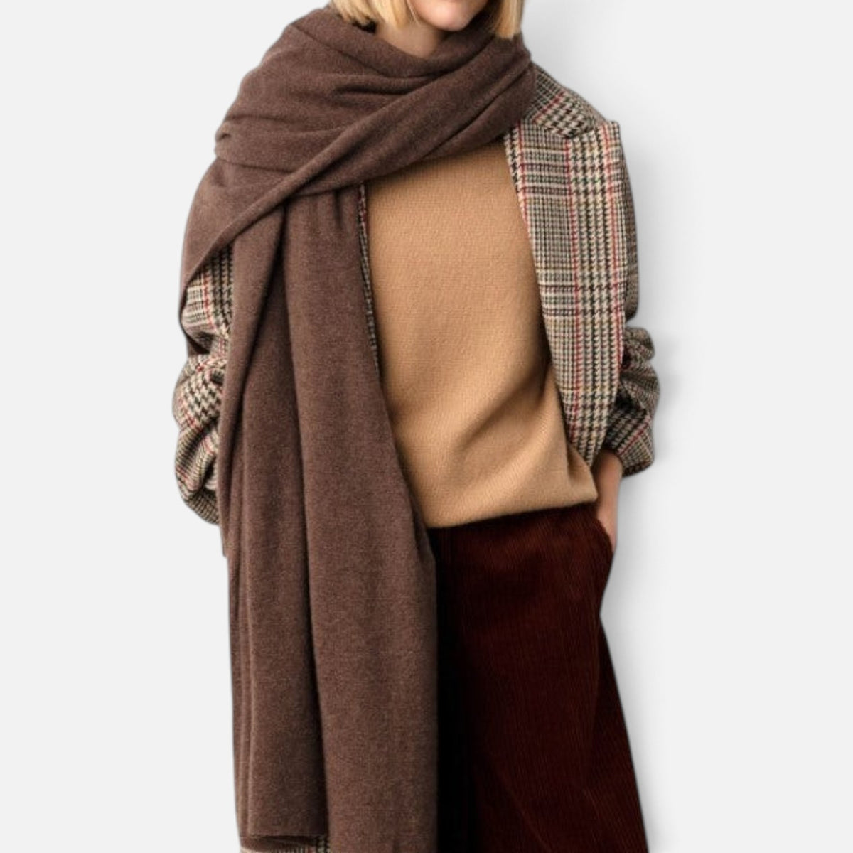 Shop Rescue Spa brown cashmere travel wrap draped over shoulders, worn as a cozy oversized scarf with a blazer.