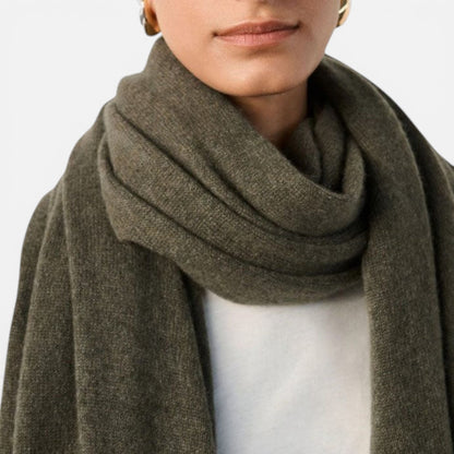 Shop Rescue Spa olive green cashmere travel wrap draped around a person&