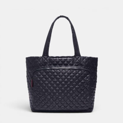 Black quilted handbag on a light gray background