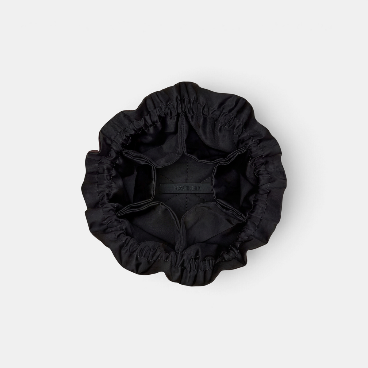 Shop Rescue Spa Naghedi Lotus Petit black neoprene jewelry pouch with drawstring closure and interior pockets