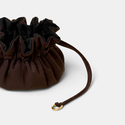 Shop Rescue Spa Lotus Petit jewelry pouch in brown neoprene with a drawstring closure and brushed gold hardware.
