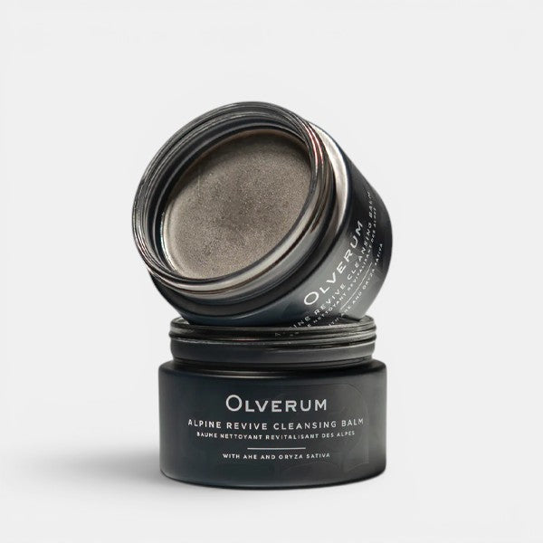 Olverum cleansing balm jar with lid open on a grey background