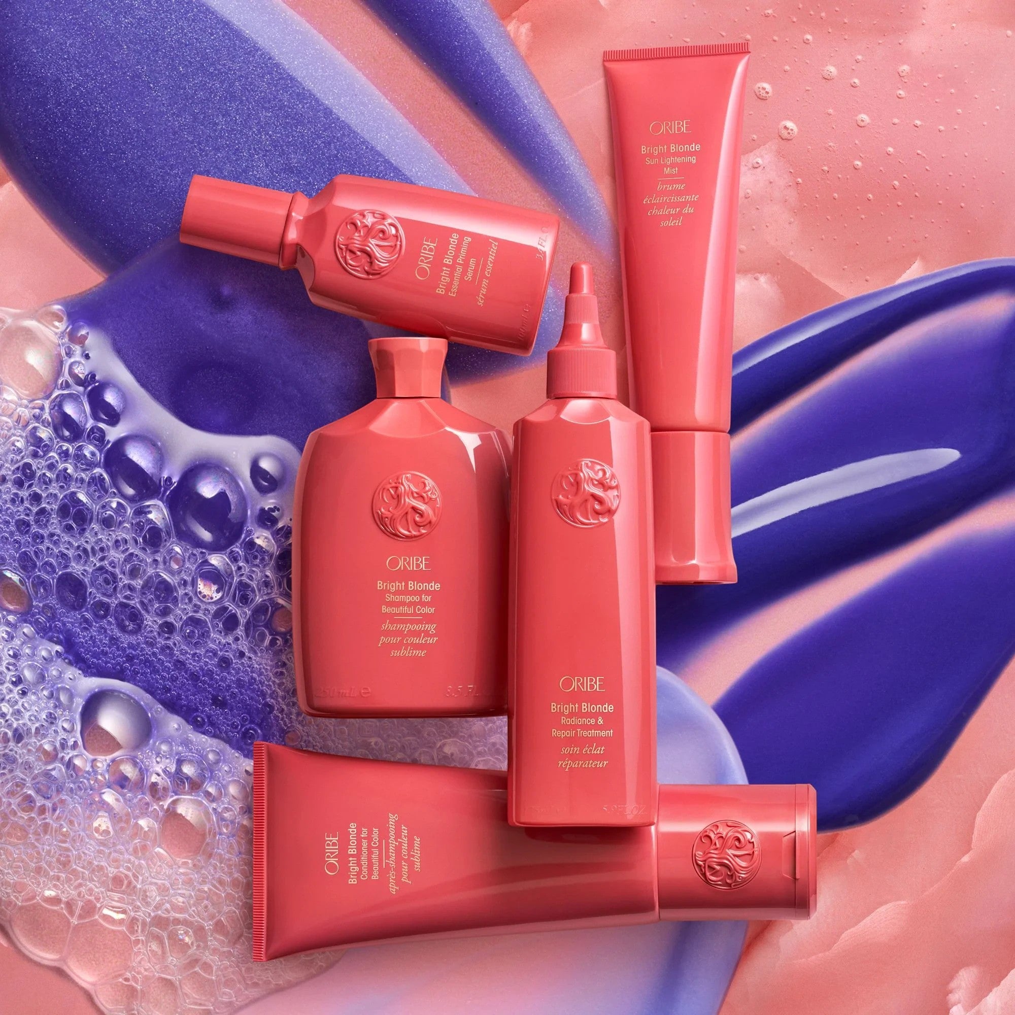 Oribe Bright Blonde Radiance &amp; Repair Treatment 175ml, a coral pink tube with violet pigments to eliminate brassiness and repair hair.