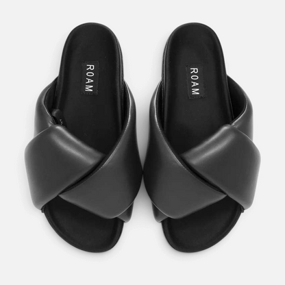 Shop Rescue Spa ROAM Foldy Puffy black vegan leather slide sandals with a cushioned memory foam cross-strap design.