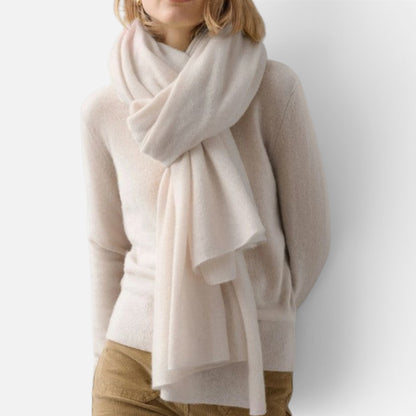 Shop Rescue Spa cashmere travel wrap in soft cream draped elegantly around a woman&