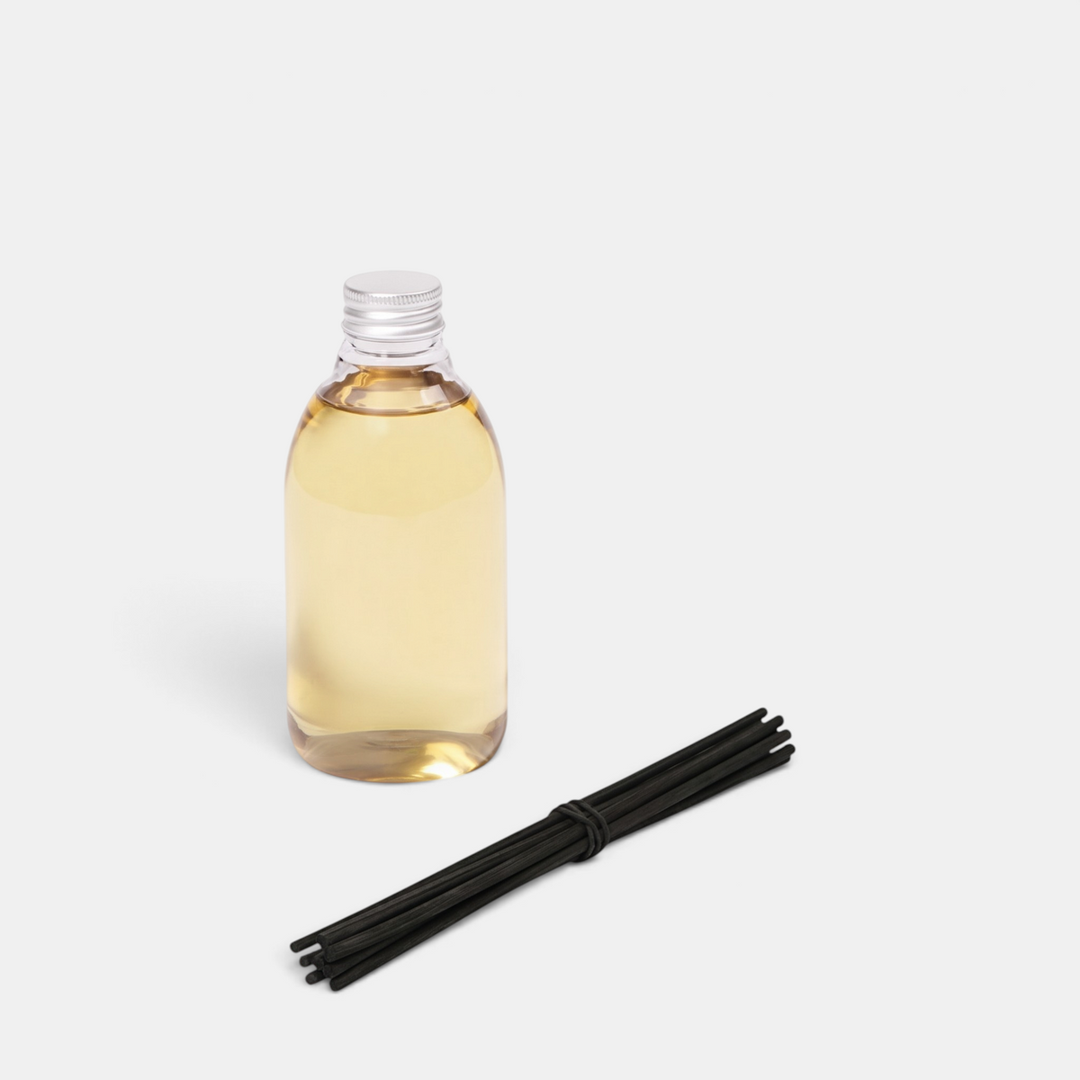 Shop Rescue Spa Le Diffuseur Altair reed diffuser with a clear glass bottle of fragrance oil and black reed sticks