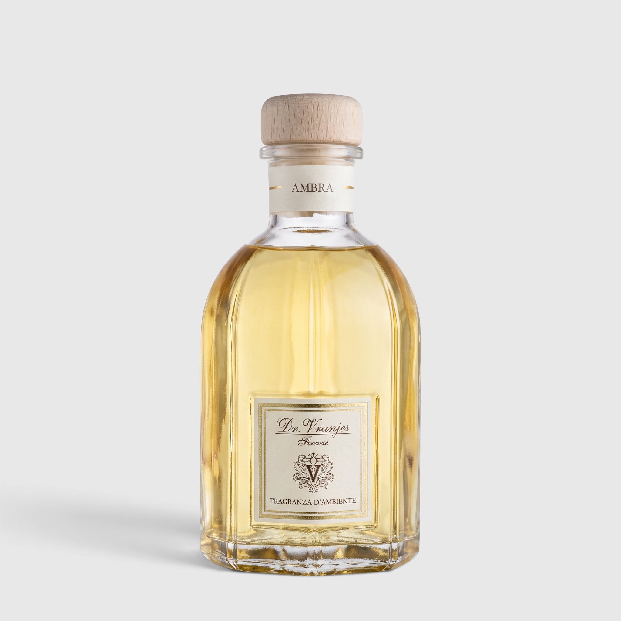 Shop Rescue Spa Ambra room diffuser in a clear glass bottle with a wooden cap and golden amber fragrance oil.