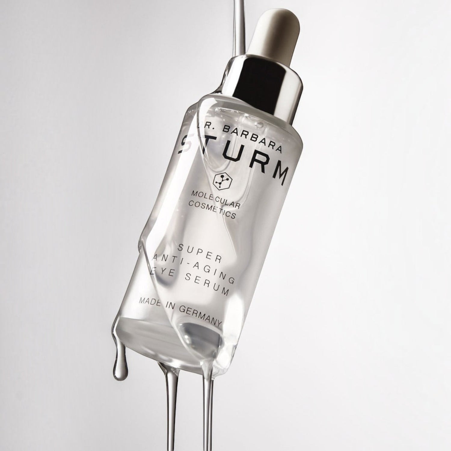 Shop Rescue Spa Dr. Barbara Sturm Super Anti-Aging Eye Serum bottle with clear liquid dripping from the dropper