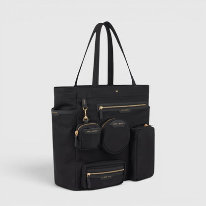 Shop Rescue Spa Anya Hindmarch black recycled nylon commuter tote with gold-tone zip pockets and external pouches.