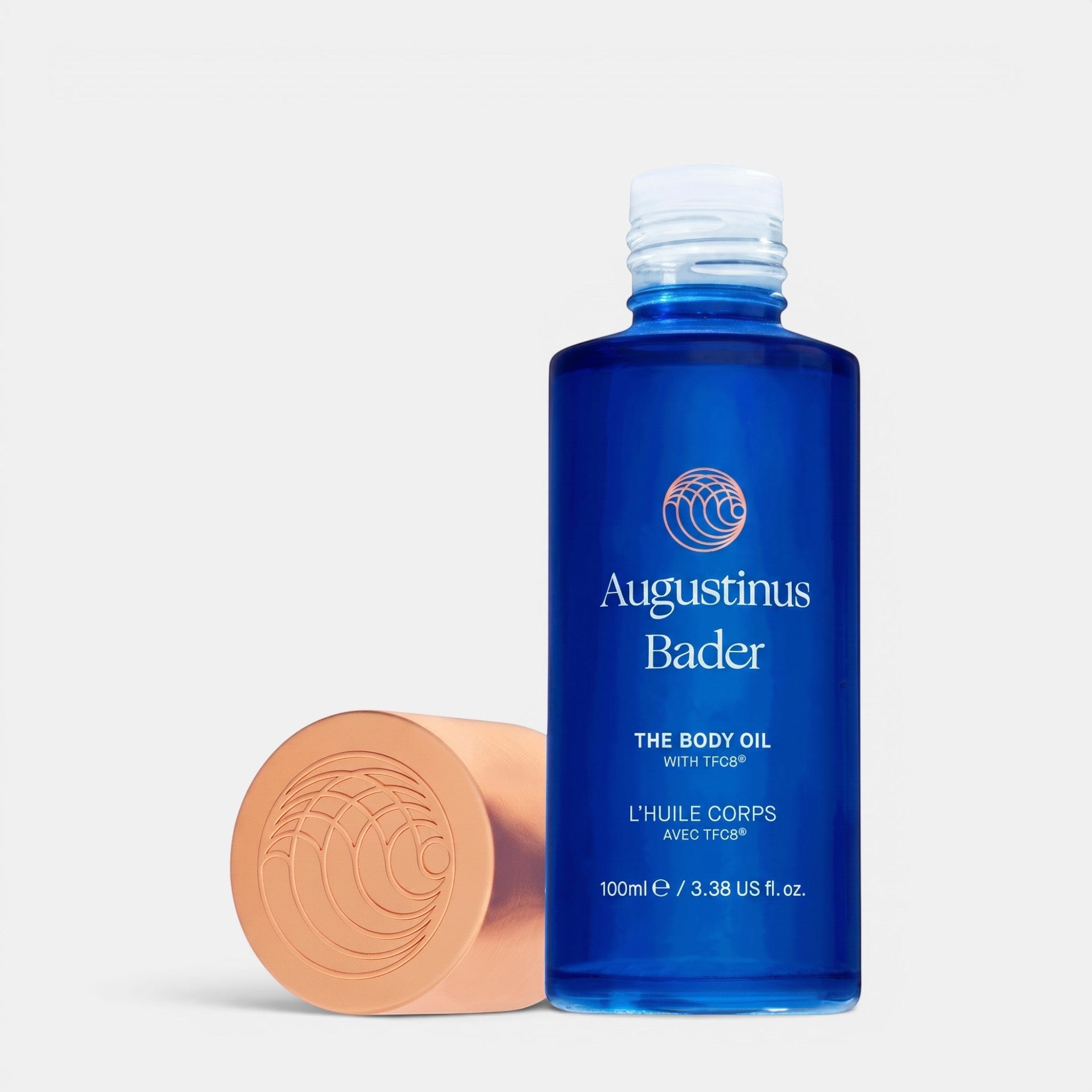 Shop Rescue Spa Augustinus Bader The Body Oil in a blue glass bottle with a metallic cap for deep skin hydration.