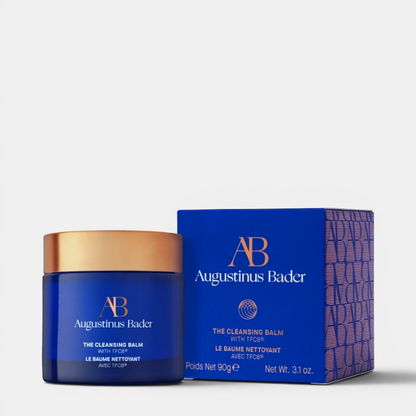 Shop Rescue Spa Augustinus Bader The Cleansing Balm in a blue glass jar with gold lid and matching blue product box.