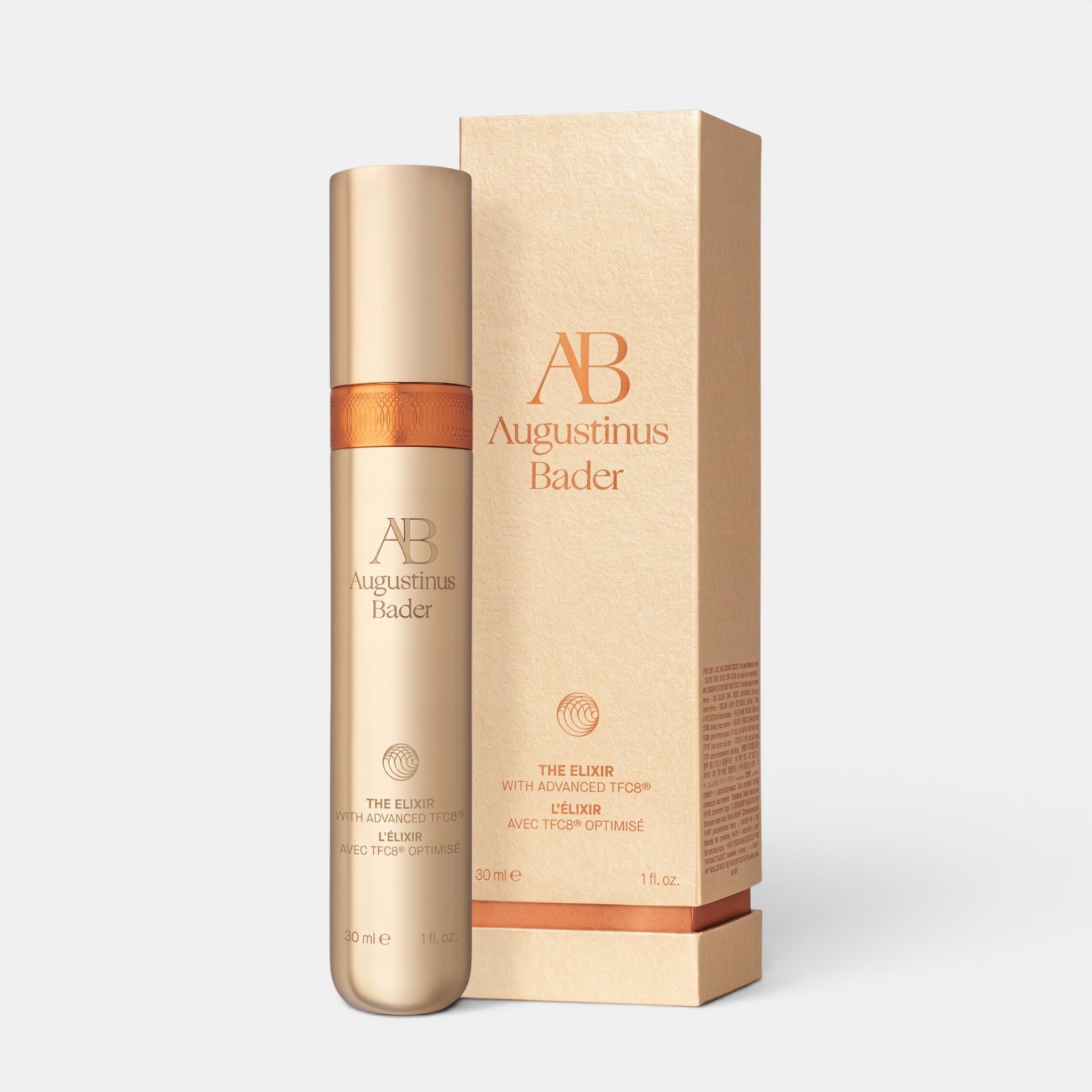 Shop Rescue Spa Augustinus Bader The Elixir anti-aging serum in a gold bottle with matching product packaging box.