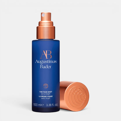 Shop Rescue Spa Augustinus Bader The Face Mist in a blue bottle with a rose gold cap for hydrating and toning skin.