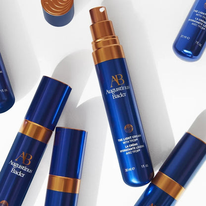 Shop Rescue Spa Augustinus Bader The Light Cream 30ml bottles with blue and bronze packaging on a white background.