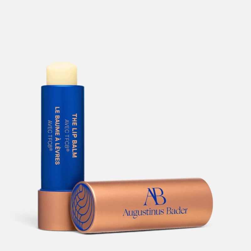 Shop Rescue Spa Augustinus Bader The Lip Balm in a blue tube with a metallic rose gold cap for hydrated, plump lips.