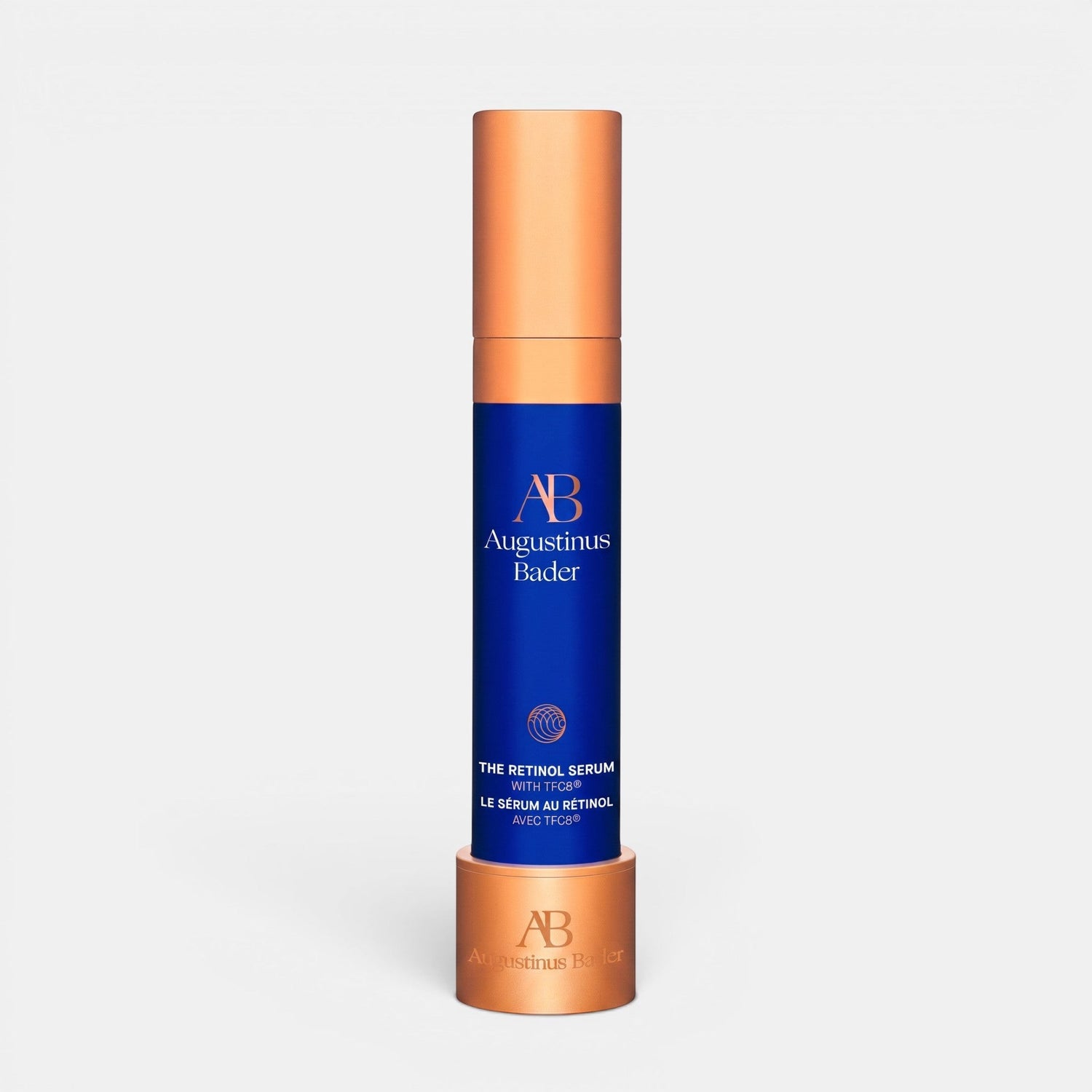 Shop Rescue Spa Augustinus Bader The Retinol Serum in a blue bottle with a metallic copper cap and matching stand.
