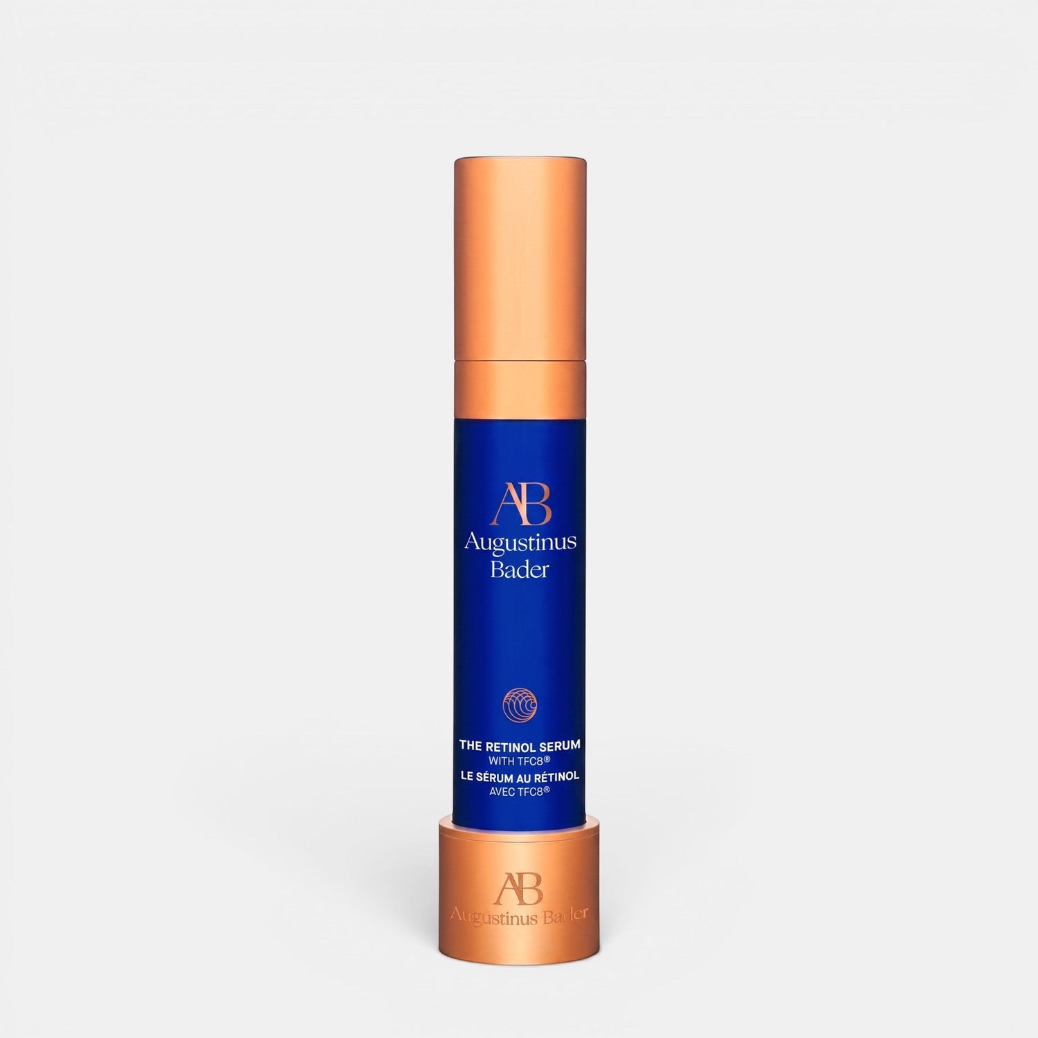 Shop Rescue Spa Augustinus Bader The Retinol Serum in a blue bottle with a metallic copper cap and base stand